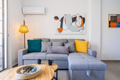 a living room with a couch and a table at Destiny 1-Bedroom Apartment in Larnaca