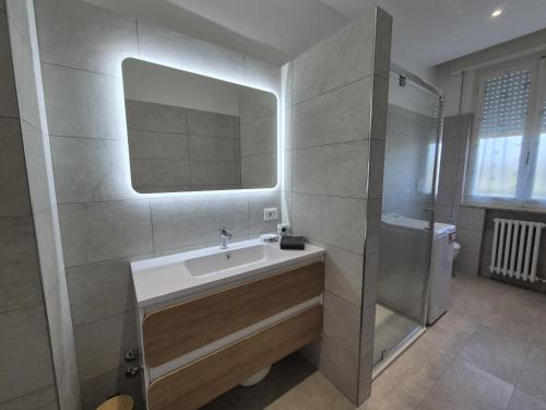 a bathroom with a sink and a mirror at allende100 in Cattolica
