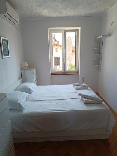 Postel nebo postele na pokoji v ubytování Apartman Paola