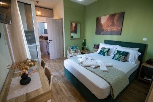 a bedroom with a large bed with green walls at vagia's studio in Alexandroupoli