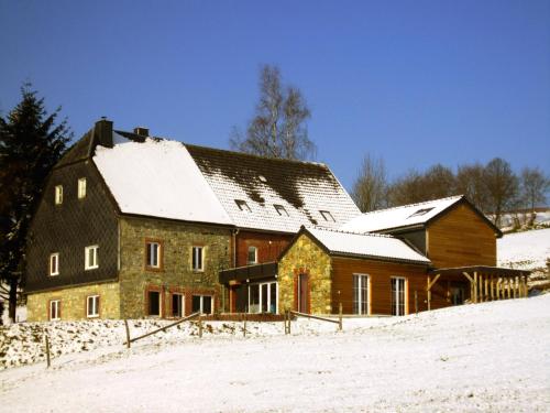 a large wooden house in the snow with snow at Lovely house with much luxury and comfort in Waimes