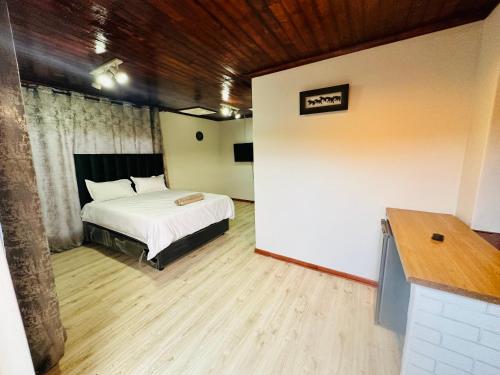 a bedroom with a bed in a room with a wall at Joy House in Cape Town