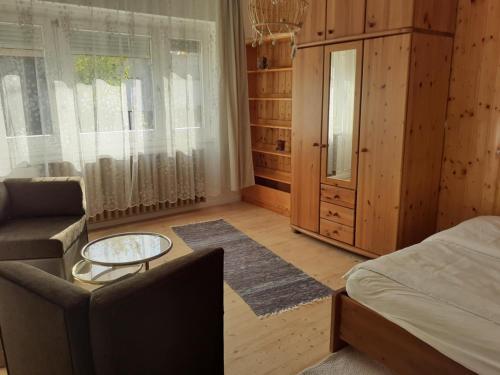 a bedroom with a bed and a couch and a table at Ibolya in Balatonfüred