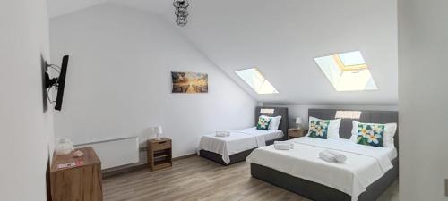 a small room with two beds and skylights at INDRA WELLNESS Retreats and Spa in Samurcaşi