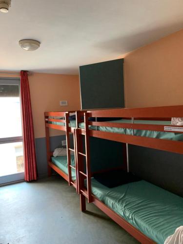 カルカソンヌにあるHostel Coeur de citéの二段ベッドが2つと窓のある部屋
