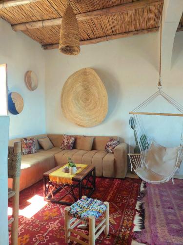 a living room with a couch and a table at Moroccan Boho Surf House in Agadir