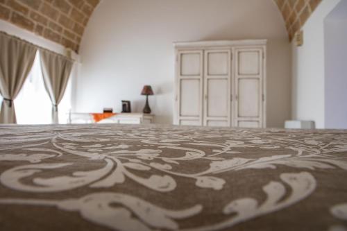 a bedroom with a bed with a design on it at grottedisileno in Castellaneta