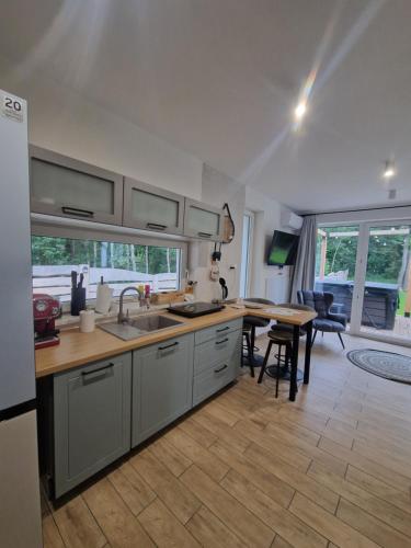 a kitchen with a sink and a table at Chill Chaty in Tarnobrzeg