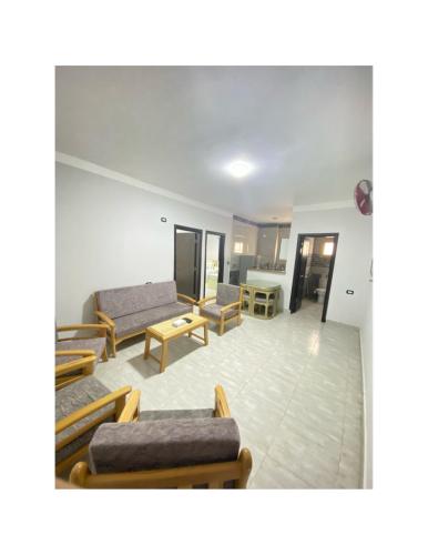 a living room with couches and chairs and a table at Jewel Inn Matrouh in Marsa Matruh