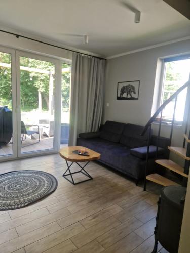 a living room with a couch and a table at Chill Chaty in Tarnobrzeg