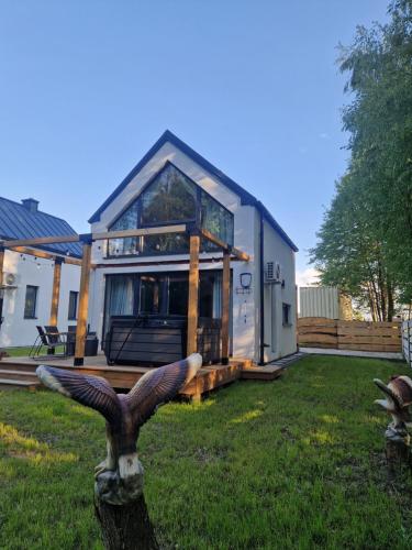 a house with a bird statue in front of it at Chill Chaty in Tarnobrzeg