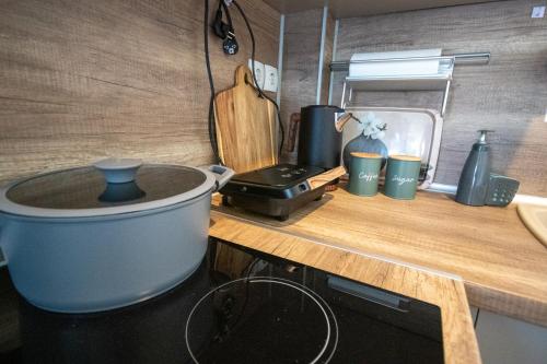 a kitchen counter with a pot on a wooden counter top at vagia's studio in Alexandroupoli