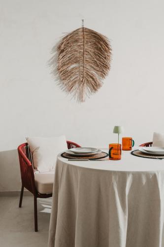 a table with plates on it with a chair at Domus Templi in Caravaca de la Cruz