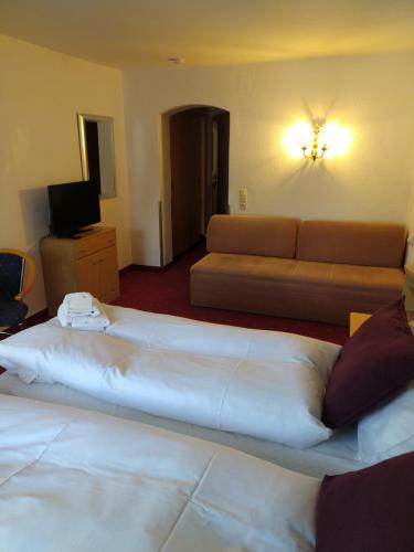 a hotel room with a bed and a couch at Langley Hotel Rendlhof in Sankt Anton am Arlberg
