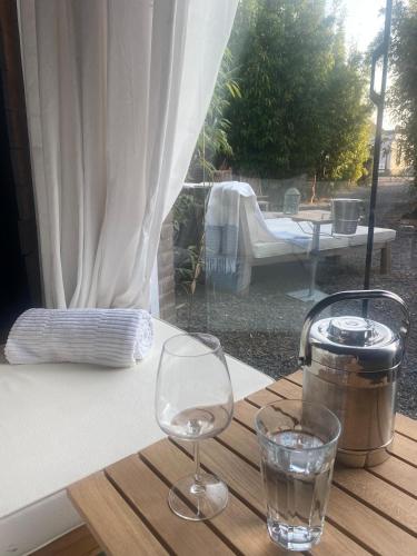 a table with a glass of water on a table at The Beach House & Winter Wonderland in Schellinkhout