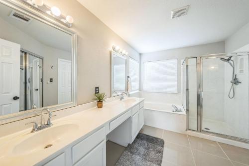 a bathroom with a double sink and a shower at Modern 4BR Gem Chic Comfort in Austin home in Austin