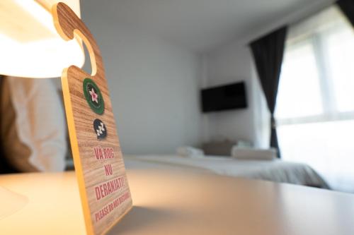 a sign on a table in a hotel room at INDRA WELLNESS Retreats and Spa in Samurcaşi