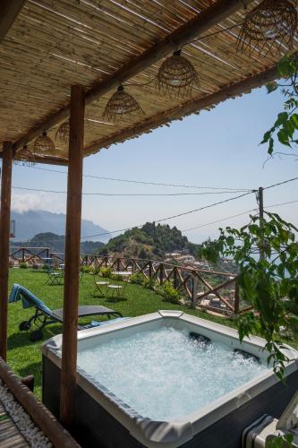 a hot tub under a pergola in a yard at Dimora la Fenice Ambra Apartment in Amalfi