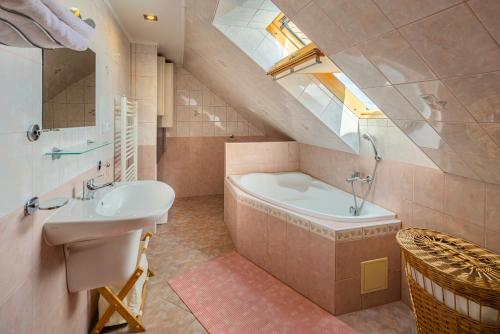 a bathroom with a sink and a bath tub at Down Town Apartment with Garden in Piešťany