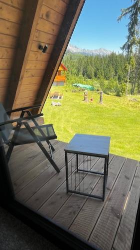 a table on a porch with a view of a field at Luxusný CHALET DANIELS Tatranská Štrba in Štrba