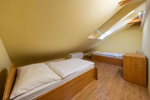 a bedroom with two beds in a attic at Down Town Apartment with Garden in Piešťany