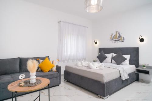 a living room with a bed and a couch at Sunelia Thassos in Skala Kallirachis