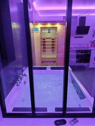 a view of a swimming pool through a window at Évasion romantique love & spa secteur Thionville Luxembourg in Basse-Yutz