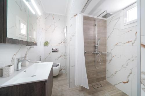 a bathroom with a shower and a sink at Sunelia Thassos in Skala Kallirachis