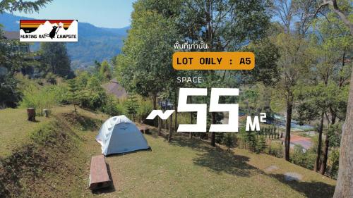 a sign with a tent on the side of a field at The Hunting Rat Campsite in Ban Tai