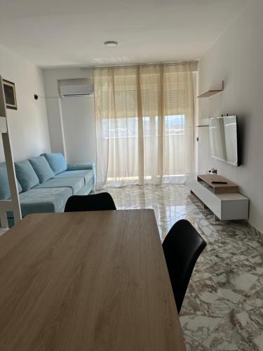 a living room with a table and a couch at Sol & Sea Apartments in Shëngjin