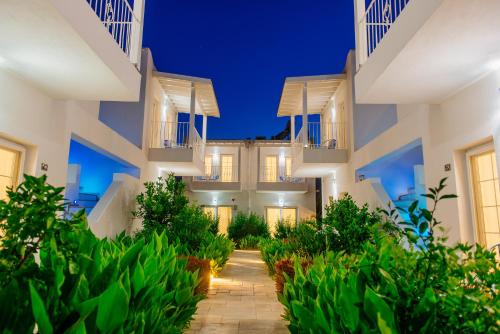 a villa with a courtyard at night at Via Farilya Hotel in Gundogan