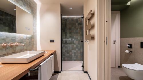 a bathroom with a sink and a toilet and a shower at Terme Preistoriche Resort & Spa in Montegrotto Terme