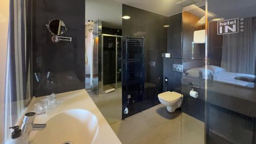 a bathroom with a sink and a toilet at Hotel IN in Biograd na Moru