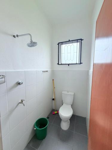 a bathroom with a toilet and a window at KAA Homestay Bajet 2 in Tawau