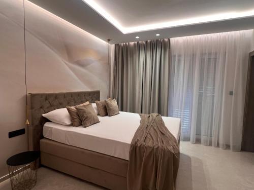 a bedroom with a bed and a large window at Apartments Adriatic Blue in Dubrovnik