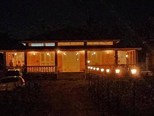 a house lit up at night with lights at The Windsor Villa in Mahirāvani