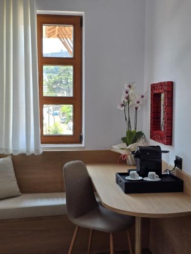 a room with a table and a window at Palorto Inn in Gjirokastër