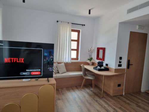 a living room with a tv and a couch at Palorto Inn in Gjirokastër