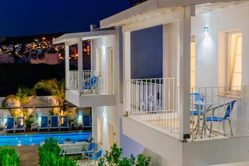 a villa with a view of the pool at night at Via Farilya Hotel in Gundogan
