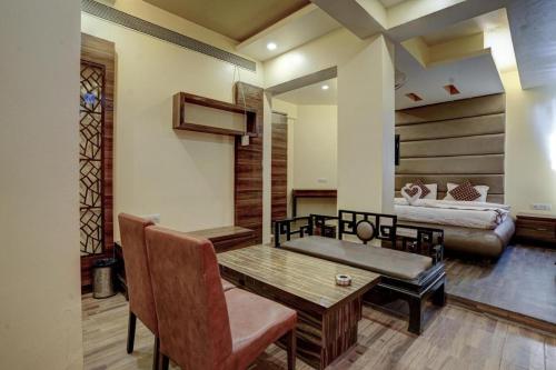 a living room with a table and a couch at Hotel Shubham Suites in Thane