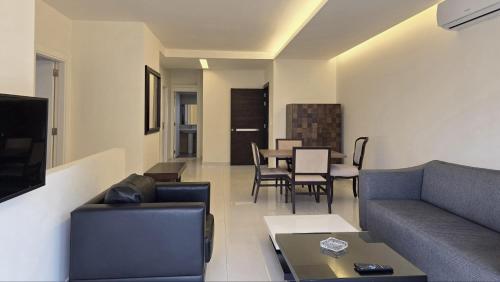 a living room with a couch and a table at Tabarja Hills apartment in ‘Ayn aş Şughayrah