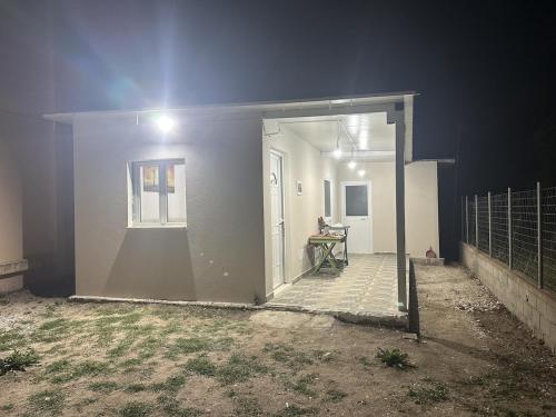 a white house with a door and a window at Apartment Himare Livadhe in Himare