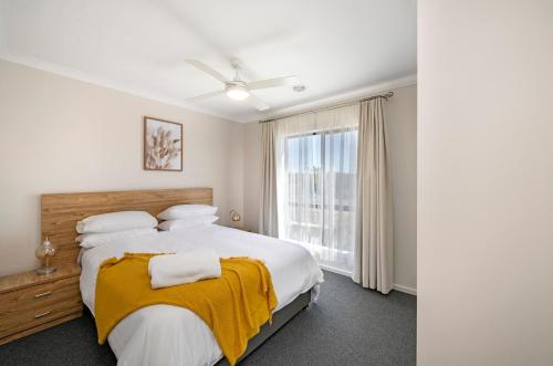 a bedroom with a large bed and a window at MV-Giraffe 4 bedroom x 3 bathroom in Hamilton