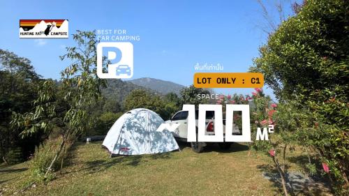 a tent and a car parked in a field at The Hunting Rat Campsite in Ban Tai