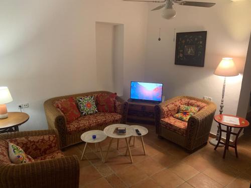 a living room with couches and a flat screen tv at Old Town Traditional House in Kos Town