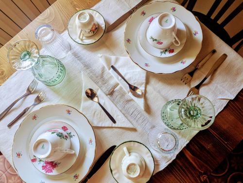 a table with plates and dishes on a table at Casa Avella Mountain Retreat in Pennapiedimonte