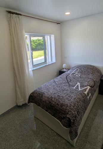 a bedroom with a bed and a window at Room Villa Ribeiro pilgrims way to SANTIAGO bike a garage for Marinhas Esposende in Esposende