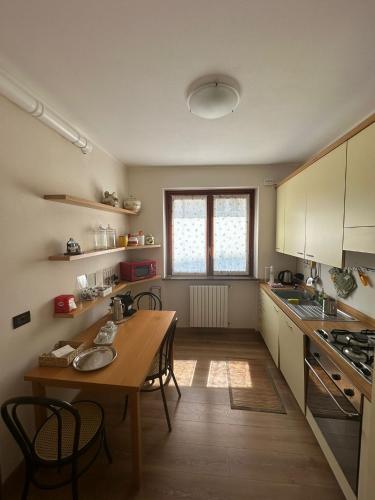 a kitchen with a wooden table and a wooden floor at Civico60 in Solbiate Arno