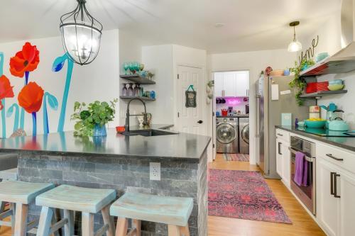 a kitchen with a counter and stools in a room at Bright Georgetown Gem N Blue Hole Park w Swings in Georgetown
