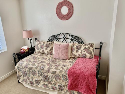 a bedroom with a bed with a red blanket at Charming Provo Home close to BYU and Utah Lake in Provo